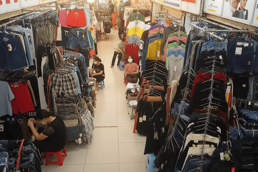 A burst of fabric colors spills from every stall, cotton shirts, flowy dresses, and cozy loungewear stacked high in rows